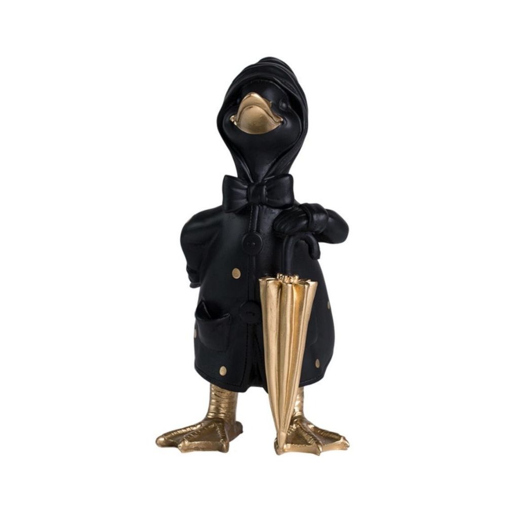 Μία μαύρη διακοσμητική πάπια με χρυσή ομπρέλα