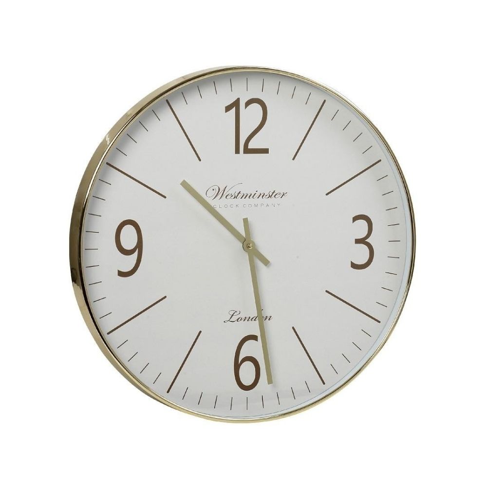 Ένα μεταλλικό ρολόι τοίχου με χρυσές λεπτομέρειες σε λευκό φόντο