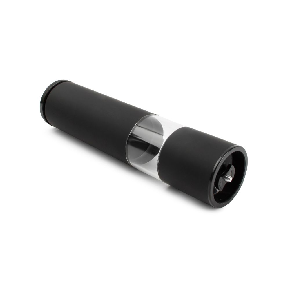 Ένας πλαγιαστός μύλος μπαχαρικών μαύρος σε λευκό φόντo